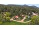 A stunning aerial view of rustic cabin homes surrounded by lush forest with mountain views at 245 N County Highway 67, Sedalia, CO 80135
