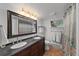 Bathroom features a double vanity, updated fixtures, and a large mirror at 245 N County Highway 67, Sedalia, CO 80135