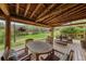 Spacious covered deck with wood ceiling and comfortable seating to enjoy the beautiful backyard at 245 N County Highway 67, Sedalia, CO 80135