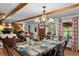 Elegant dining room with a rustic table setting, decorative chandelier and views to the living room at 245 N County Highway 67, Sedalia, CO 80135