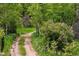 Winding dirt road through lush greenery and trees at 245 N County Highway 67, Sedalia, CO 80135