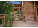 A charming wooden walkway gate to the home's exterior, surrounded by lush greenery at 245 N County Highway 67, Sedalia, CO 80135
