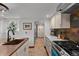 Farmhouse kitchen features soapstone counters, gas range, tile floors, copper sink, and ample storage at 245 N County Highway 67, Sedalia, CO 80135