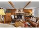 Inviting living room with a stone fireplace, beamed ceilings, and comfortable leather seating at 245 N County Highway 67, Sedalia, CO 80135