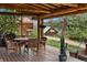 Charming porch features wood beams, wood flooring, and outdoor dining set at 245 N County Highway 67, Sedalia, CO 80135