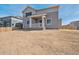 Back of the house featuring a small patio and a large unfinished dirt yard at 10145 Quentin Ct, Commerce City, CO 80022