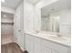 Bright bathroom features a double sink vanity, large mirror, and a glass-enclosed shower at 10145 Quentin Ct, Commerce City, CO 80022