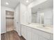 Modern bathroom featuring double sinks, a large mirror, walk-in shower, and walk in closet, providing ample space at 10145 Quentin Ct, Commerce City, CO 80022