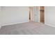 Carpeted bedroom featuring a large closet and an open doorway to the rest of the house at 10145 Quentin Ct, Commerce City, CO 80022
