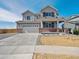 Charming two-story home with a covered front porch, a two-car garage, and professionally landscaped front yard at 10145 Quentin Ct, Commerce City, CO 80022