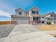 Charming two-story home with a covered front porch, a two-car garage, and professionally landscaped front yard at 10145 Quentin Ct, Commerce City, CO 80022