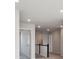 Hallway with neutral walls, plush carpet, modern lighting, and wooden railings, creating a bright and welcoming space at 10145 Quentin Ct, Commerce City, CO 80022