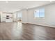 Open-concept living room featuring hardwood flooring, neutral paint, recessed lighting, and large windows at 10145 Quentin Ct, Commerce City, CO 80022