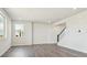 Bright living room featuring hardwood floors, recessed lighting, and staircase with white and black railings at 10145 Quentin Ct, Commerce City, CO 80022