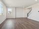 Bright living room featuring hardwood floors, recessed lighting, and staircase with white and black railings at 10145 Quentin Ct, Commerce City, CO 80022