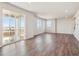 Expansive living room featuring hardwood floors, large sliding glass doors to a patio, and bright natural light at 10145 Quentin Ct, Commerce City, CO 80022