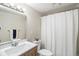 Updated bathroom featuring a modern vanity, toilet, and shower with a white curtain at 500 Manhattan Dr # B1, Boulder, CO 80303