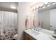 Well-lit bathroom featuring a single sink vanity, mirror, and a shower with floral curtain at 500 Manhattan Dr # B1, Boulder, CO 80303