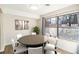 Well-lit dining room with a round table, six chairs, and a large window with neighborhood views at 500 Manhattan Dr # B1, Boulder, CO 80303