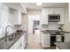 Well-equipped kitchen with modern appliances, sleek countertops, and a view into the next room at 500 Manhattan Dr # B1, Boulder, CO 80303