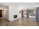 Open living area with a brick fireplace, wood floors, and sliding glass doors to the outside at 500 Manhattan Dr # B1, Boulder, CO 80303