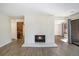 Spacious living room with a white brick fireplace, wood-look flooring, and a contemporary design at 500 Manhattan Dr # B1, Boulder, CO 80303