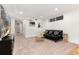 Finished basement featuring comfortable seating, carpeted floors, and a hallway, creating a cozy entertainment space at 3044 W 37Th Ave, Denver, CO 80211
