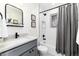 Modern bathroom featuring sleek fixtures, subway tile, and a combination shower/tub, providing a clean spa-like experience at 3044 W 37Th Ave, Denver, CO 80211