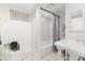 Bright, clean bathroom featuring a shower-tub combo with new fixtures and elegant tiling at 3044 W 37Th Ave, Denver, CO 80211