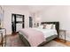 Stylish bedroom with a comfortable bed, decorative closet, and ample natural light for a relaxing retreat at 3044 W 37Th Ave, Denver, CO 80211
