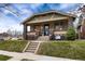 Attractive exterior of a home with a covered porch, manicured lawn, and classic architectural details at 3044 W 37Th Ave, Denver, CO 80211
