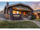 Inviting two-story home showcasing brick details, covered porch, and well-maintained front yard at 3044 W 37Th Ave, Denver, CO 80211