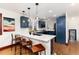 Modern kitchen featuring blue cabinets, pendant lighting, quartz countertops, and stainless steel appliances for stylish cooking at 3044 W 37Th Ave, Denver, CO 80211