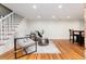 Bright living room featuring hardwood floors, comfortable seating, and staircase access at 3044 W 37Th Ave, Denver, CO 80211