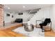 Cozy living room featuring hardwood floors, exposed brick, and stylish decor with updated lighting at 3044 W 37Th Ave, Denver, CO 80211