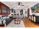 Open-concept living room with hardwood floors, modern furnishings, and seamless flow to the kitchen at 3044 W 37Th Ave, Denver, CO 80211