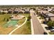 Scenic aerial view of the neighborhood showcasing a playground, basketball court, and nearby homes at 12563 Grape St, Thornton, CO 80241