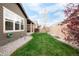 Manicured backyard featuring a lawn, flowerbed, and a patio area at 12563 Grape St, Thornton, CO 80241