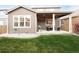 Backyard patio with string lights, outdoor furniture, a barbecue grill, and a lush lawn at 12563 Grape St, Thornton, CO 80241