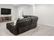 Spacious finished basement featuring a large sectional, media center, and a cozy electric fireplace at 12563 Grape St, Thornton, CO 80241