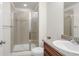 Bathroom with a tiled shower, toilet, and sink with a granite countertop at 12563 Grape St, Thornton, CO 80241