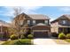 Beautiful two-story home boasts manicured lawn and a two-car garage, with stone accents on the facade at 12563 Grape St, Thornton, CO 80241