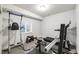 Basement gym featuring a window, treadmill, weight rack, and various exercise machines at 12563 Grape St, Thornton, CO 80241