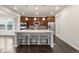 Gourmet kitchen features a large island with seating, stainless steel appliances, and dark wood cabinets at 12563 Grape St, Thornton, CO 80241