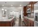 Modern kitchen boasts stainless appliances, dark wood cabinets, and granite countertops at 12563 Grape St, Thornton, CO 80241