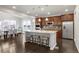 Open-concept kitchen with stainless steel appliances, a large island with seating, and adjacent dining area at 12563 Grape St, Thornton, CO 80241