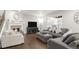 Comfortable living room features fireplace, large TV, plush seating, and natural light at 12563 Grape St, Thornton, CO 80241