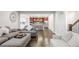 Bright living room with wood floors, fireplace, and modern furnishings, connects to the kitchen at 12563 Grape St, Thornton, CO 80241