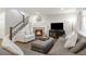 Comfortable living room features a fireplace, plush seating, and natural light at 12563 Grape St, Thornton, CO 80241