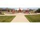 Inviting community playground with slides, climbing structures, and ample green space for recreation at 12563 Grape St, Thornton, CO 80241